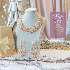 Giving out an elegant vibe owing to its sparkling stone mix! A versatile set encrusted with nauratan/CZ stones and pearl moti. The set includes a pair of beautiful earrings. Approximate earrings length is 4" Gold-plated on high-quality brass as base metal. Niti Set (CZ) is in-stock & ready-to-ship. Delivery time frame for Niti Set (Nauratan) is 4-6 weeks. For custom or urgent requests, please contactsupport@alacouture.com. Please Note: We use faux stones and beads in all of our jewelry. Elegant Stone Work Sets For Gift, Traditional Jewelry Sets With Sparkling Stones For Gifts, Traditional Festive Jewelry Sets With Sparkling Stones, Festive Traditional Jewelry Sets With Sparkling Stones, Traditional Jewelry Sets With Sparkling Stones For Festive Occasions, Dazzling Jewelry Sets With Sparkling Stones For Festivities, Elegant Pearl Jewelry Set For Gift, Elegant Pearl Sets With Stone Work, Pearl Sets With Stone Work For Celebration