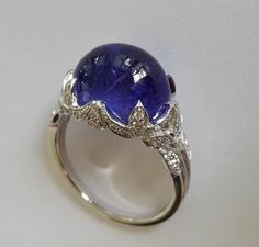 Dalben Tanzanite Diamond Gold Ring | From a unique collection of vintage cocktail rings at https://www.1stdibs.com/jewelry/rings/cocktail-rings/ Luxury Hallmarked Oval Cabochon Sapphire Ring, Formal Polished Finish Oval Cabochon Sapphire Ring, Luxury Cabochon Diamond Ring For Formal Occasions, Exquisite Formal Gemstone Cabochons, Formal Fine Jewelry Gemstone Cabochons, Luxury Formal Cabochon Diamond Ring, Classic Cabochon Sapphire Ring For Formal Occasions, Luxury White Gold Diamond Cabochons, Modern Sapphire Ring Oval Cabochon For Formal Occasions