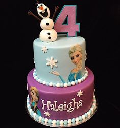 a frozen princess birthday cake with the number four on top