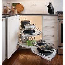 an open kitchen cabinet with pots and pans in it