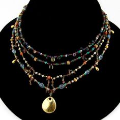 "Vintage multi-strand necklace, made of different form multi-gemstone beads with hammered oval form 18 K (.750) yellow gold pendant and toggle clasp. This outstanding necklace is 21 1/2\" long and weighs 40.6 grams. EA1418" Multi Pendant Necklace, Thrifting Manifestation, Multi Strand Beaded Necklace, Antique Jewelry Necklace, Multi Pendant, Jewelry Tattoo, Jewellery Inspiration, Gemstone Beaded Necklace, Craft Jewelry