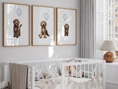 a baby's room with three pictures hanging on the wall and a crib