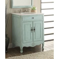 a bathroom vanity with a mirror above it and a rug on the floor next to it