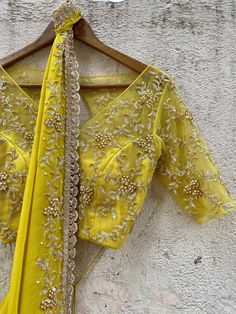 A two-piece mustard saree set from the Priti Sahni collection. This gorgeous mustard georgette pre-stitched ruffled saree with pearl and zardozi rose gold hand embroidery and scalloped edging is paired with a mustard net embroidered tie up blouse. Fitted Yellow Pre-draped Saree With Pallu, Designer Pre-draped Yellow Saree, Elegant Yellow Silk Sharara, Yellow Designer Wear Pre-draped Saree, Yellow Pre-draped Designer Saree, Festive Yellow Fitted Pre-draped Saree, Gold Dola Silk Blouse With Dupatta, Yellow Georgette Pre-draped Saree With Pallu, Transitional Designer Yellow Pre-draped Saree