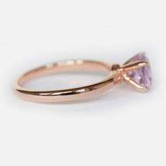 Engagement Ring Details 14k Solid Rose Gold (Also available in White and Yellow Gold, Please select at checkout) 2mm (Approximate Band Width) Amethyst (Center Stone) Round 7mm (Center Stone Dimensions) 1.10 Carats (Average Center Stone Weight) Ring can be resized from 3-10, Metal can be made in 14, 18K/ White, Yellow and Rose Gold. For custom order this ring with a different stone, please contact us. - - - SHIPPING POLICY - - - This ring is made to order, please allow 7-10 business days for proc Classic Amethyst Promise Ring With Center Stone, Wedding Pink Gold Sapphire Ring With Prong Setting, Classic Amethyst Round Cut Birthstone Ring, Classic Amethyst Ring With Round Cut, Delicate Solitaire Ring With Round Band For Wedding, Classic Amethyst Birthstone Ring With Round Cut, Classic Amethyst Birthstone Ring For Wedding, Dainty Amethyst Wedding Ring With Prong Setting, Rose Gold Amethyst Promise Ring