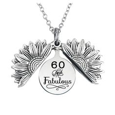 a necklace with the words 60 and fabulous written in black ink on it's front