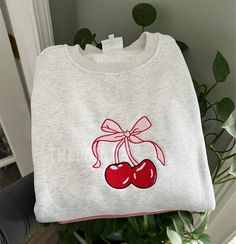 90% cotton/10% polyester. Embroidered unisex true to size crewneck sweatshirt. Sizes small-3X, please refer to the size chart. If you want an oversized fit- size up one size. Pink Embroidered Sweatshirt, Embroidered Sweatshirt Ideas, Embroidery Sweatshirt Ideas, Cherry Sweatshirt, Custom Hoodies Ideas, Crew Neck Embroidery, Sweatshirt Design Ideas, Cute Crewneck Sweatshirt, Shirts Embroidery