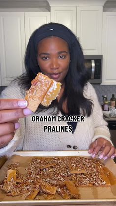 a woman holding up a cracker in front of her face with the caption graham cracker pralies