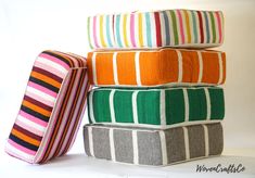 four different colored pillows stacked on top of each other