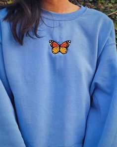 This Carolina blue crewneck is embroidered with an orange and yellow Monarch butterfly. Whether it's for yourself or a gift, get cozy, comfy, and stylish with this embroidered sweatshirt. Crewnecks are embroidered with a one-of-a-kind design inspired by places, experiences, and adventures! ⭐  PRODUCT DETAILS * Unisex Sizing * Sweatshirts: 50% cotton, 50% polyester * T-Shirts: 100% cotton * Size up 1-2 sizes for a looser comfy fit ⭐  CARE INSTRUCTIONS Wash with cold water. Hang drying is recommen Blue Hoodie Embroidery, Cute Blue Crew Neck Hoodie, Casual Embroidered Sweatshirt For Fall, Blue Crew Neck Hoodie With Embroidered Graphics, Blue Embroidered Crew Neck Hoodie, Casual Sweatshirt With Custom Embroidery Relaxed Fit, Casual Relaxed Fit Sweatshirt With Custom Embroidery, Blue Hoodie With Custom Embroidery, Blue Custom Embroidered Hoodie