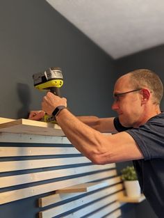 Adding two more slats onto the wall brought it higher and made it all look better. Horizontal Wood Slats On Wall, Horizontal Slats Wall, Wood Slat Wall With Floating Shelves, Wall Of Wooden Slats, Horizontal Wood Slat Wall With Shelves, 1x2 Accent Wall Horizontal, Horizontal Wall Slats, 2x2 Slat Wall, Wooden Slat Wall With Shelves