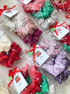 many different types of hair bows are on the table with tags attached to them and tied together