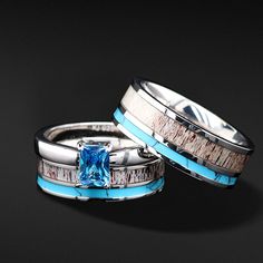 two wedding bands with blue topaz and white bottomaz inlays are shown next to each other