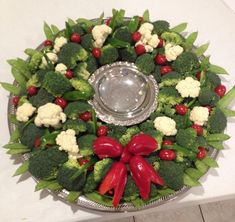 a platter filled with broccoli, cauliflower and other veggies