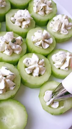 green apples with white frosting on top are sitting on a plate, ready to be eaten