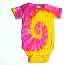 a pink and yellow tie - dyed bodysuit on a white background