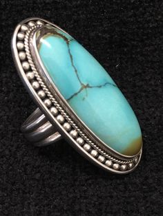 "Ring ~ Artist: Teresa Bradford-Cole Natural Stone Oval Turquoise Heavy Gauge Sterling Silver Be bold in style with this stunning long turquoise stone It features a long oval natural stone Many tribes considered turquoise to be a stone of the sky and wearing items of turquoise jewelry provided protection, good health, and long life. Size: 8 Length: 1 3/4\" Width:3/4 You deserve to know about my fabulous Treasure chest Modern Tribal Jewelry, Statement Piece Jewelry, Art to Wear Jewelry, Fantastic Oval Turquoise Ring With Stones, Elegant Untreated Blue Turquoise Ring, Elegant Blue Turquoise Ring, Turquoise Stone Jewelry, Statement Piece Jewelry, Ring Inspiration, Turquoise Jewelry Native American, Pacific Grove, Southwest Jewelry