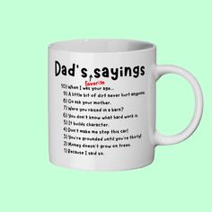 a white coffee mug with the words dad's sayings on it, against a green background