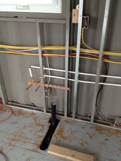 an electrical box with wires and other equipment in the room that is being built into the wall