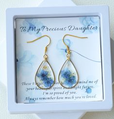 To My Precious Daughter Earrings | Forget Me Not Flower Earrings | Dangle Drop Earrings | Real Pressed Flower Earrings | Gift for Daughter | Birthday Gift for Her 🌿The "To My Precious Daughter" Forget Me Not Flower Earrings are a stunning and sentimental piece of jewelry that serves as a heartfelt gift for daughters. These earrings feature real forget-me-not flowers that have been delicately pressed and encased in epoxy resin, creating a unique and eye-catching design. 🌿The dangle drop style a Delicate Flower Earrings For Mother's Day Anniversary, Birth Flower Earrings For Anniversary, Floral Birth Flower Earrings For Anniversary, Anniversary Birth Flower Earrings, Dainty Flower Earrings For Mother's Day Anniversary, Dainty Flower Earrings For Anniversary And Mother's Day, Delicate Teardrop Flower Earrings For Anniversary, Dainty Birth Flower Earrings For Gift, Round Flower Earrings For Mother's Day Gift