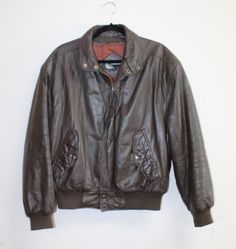 Vintage Members Only brown leather bomber jacket. Size 40. Cool retro 70s 80s bomber jacket. Brown leather, ribbed sleeve cuffs and waist band, two side pockets with snap closure, YKK zipper, two interior pockets, zipper liner is no longer with the jacket, there is a quilted lining. Very good condition, perfectly broken in, there is a small tear in the lining (view photo). Measurements: Chest: 48" Shoulders: 21" Length: 25" Sleeves 24" All measurements taken on the outside of the jacket with it Vintage Brown Outerwear For Winter Streetwear, Casual Vintage Brown Leather Jacket For Winter, Vintage Outerwear With Ribbed Cuffs For Fall, Vintage Fall Outerwear With Ribbed Cuffs, Fall Vintage Outerwear With Ribbed Cuffs, Line Pic, Members Only, Retro 70s, Halloween Shopping