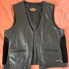 Harley Davidson Black Leather Vest. Size Large. Received As Gift And Do Not Like. Never Worn. Classic Leather Vest For Workwear, Black Leather Vest For Fall, Black Leather Vest With Pockets, Fitted Black Leather Vest, Black Business Vest For Fall, Classic Black Leather Vest, Classic Black Vest With Pockets, Black Biker Leather Jacket For Formal Occasions, Black Casual Leather Vest