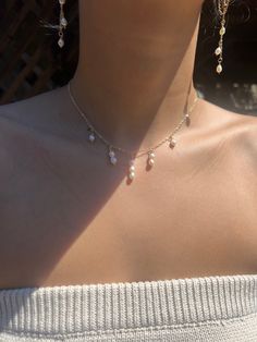 This exquisite Waterfall Necklace features delicate, hand-wrapped pearls in a cascading waterfall pattern. The adjustable 14"-17" chain ensures a perfect fit with a lobster clasp. Elevate any outfit with this stunning accessory. All gold-filled. Elegant Lariat Jewelry With Dangling Beads, Pearl Drop Necklace For Party, Elegant Beaded Drop Necklace, Gold Drop Necklace With Pearl For Party, Gold Pearl Chain Backdrop Necklace, Elegant Adjustable Drop Necklace With Dangling Beads, Pearl Dangle Necklace With Charm For Party, Dangle Pearl Charm Necklace For Party, Dainty Dangling Beads Jewelry For Party