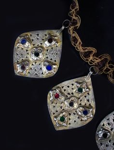 Necklace made from silver gilt 19th century Meknes Moroccan pendants with inlaid glass on Italian silk ribbon with bronze clasp. Designed by Linda Pastorino. Measures 11" L, each pendant approx. 3" L x 2.5 " W. Ceremonial Silver Jewelry With Detachable Pendant, Antique Necklaces With Large Pendant For Festivals, Antique Necklace With Large Pendant For Festival, Ceremonial Silver Necklace With Detachable Pendant, Ceremonial Large Pendant Bronze Jewelry, Ceremonial Medallion Necklace For Festivals, Traditional Large Pendant Necklace For Celebrations, Traditional Necklace With Large Pendant For Celebrations, Silver Brass Jewelry With Detachable Pendant