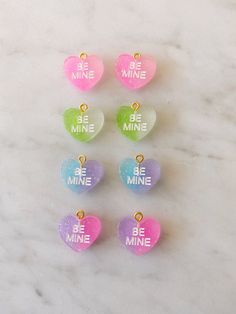 Obsessed is an understatement! Pay homage to your favorite Valentine's Day candies with these adorable be mine huggies. Available in both pierced hoops or clip on styles (for those without their ears pierced) these earrings are super fun and eye catching. Choose from a matte candy heart in a number of different colors or a two color glitter heart. The perfect size they are noticeable without being overwhelming. The charms are lightweight and easy to wear. Hoops are gold plated and nickel free. M Cute Heart Charm Earrings As Gift, Sweet Heart Earrings For Valentine's Day, Cute Nickel-free Heart Earrings For Valentine's Day, Cute Heart Beads Earrings For Valentine's Day, Cute Heart Earrings For Valentine's Day, Cute Heart Charm Earrings For Valentine's Day, Cute Heart-shaped Earrings For Valentine's Day, Cute Heart Earrings For Birthday, Personalized Cute Heart Earrings