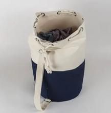 a blue and white tote bag sitting on top of a table