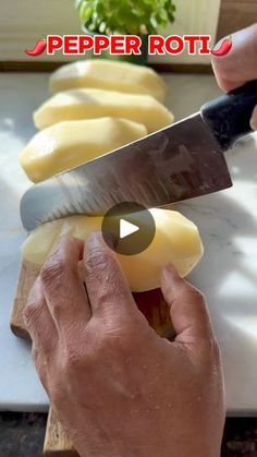 a person cutting cheese with a large knife