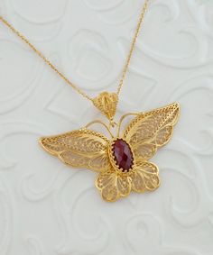 Gold Ruby Corundum Butterfly Silver Pendant Necklace, 925 Sterling Silver Gold Plated Artisan Handcrafted Filigree Pendant Handmade Necklace Necklace Monarch Butterfly, ornate butterfly, gold large necklace, one of a kind, vintage big pendant, victorian necklace Gemstone: Ruby Corundum 7x14mm. Material: 925K Sterling Silver ( 18K Gold Plated ). ( NICKEL FREE ) Chain Length:  -21 Inches ( 53 cm ) -18 Inches + 2 Inches Extender ( 46 cm + 5 cm Extender ) Pendant height and width: -2.35 Inch X 1.4 Inch // 6cm X 3.5cm  FREE, FAST AND TRACKABLE SHIPPING FOR ALL EU COUNTRIES AND USA. COMES WİTH VELVET POUCH AND LUXURY GİFT BOX. Made from our finest sterling silver with gold filled, this necklace is stunning and adds the perfect touch to any outfit. This necklace adds a touch of elegance while mak Exquisite Filigree Pendant Jewelry, Traditional Oval Filigree Necklaces, Exquisite Filigree Jewelry Gift, Carved Yellow Gold Necklace Perfect For Gift, Carved Yellow Gold Necklace, Carved Yellow Gold Necklace For Gift, Handmade Ornate Necklaces For Anniversary, Traditional Oval Filigree Necklace, Filigree Pendant Jewelry As Gift