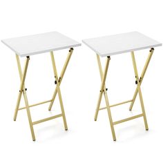 two white tables sitting side by side on top of each other, one with a gold frame