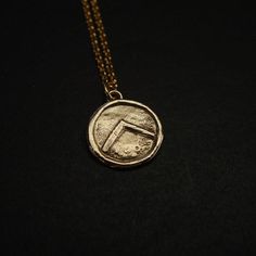 Hand sculpted dainty Spartan Shield necklace. The charm has been beaten up some to show use in battle. Small and dainty version for women.The letter lambda (Λ), standing for Laconia (administrative capital of Sparta) or Lacedaemon (ancient name for the city of Sparta), which was painted on the Spartans' shields, was first adopted in the 420s BC, and quickly became a widely known Spartan symbol. Military families passed on their shields to each generation as family heirlooms.- Hand sculpted charm Symbolic Coin-shaped Brass Necklaces, Handmade Symbolic Pendant Coin Necklace, Handmade Symbolic Coin Pendant Necklace, Symbolic Handmade Coin Necklaces, Symbolic Brass Coin Necklace, Gold Medallion Hand Cast Jewelry, Gold Medallion Jewelry Hand Cast, Symbolic Bronze Jewelry With Coin Pendant, Ancient Brass Round Pendant Necklace