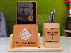 a wooden desk set with a cell phone and pen holder