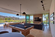 a pool table in the middle of a living room