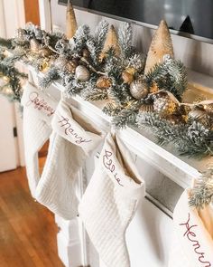 stockings are hung on the mantle with christmas decorations