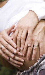 two people holding each other with their hands on top of one another's stomach