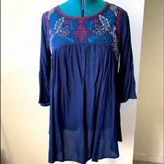 Long Tunic Blouse. Navy Blue With Embroidery Along Neckline. Bell Sleeves. 30” Long Blue Long Sleeve Blouse With Floral Embroidery, Blue Folk Style Top For Spring, Blue Blouse With Geometric Embroidery For Spring, Bohemian Blue Tops With Embroidered Sleeves, Blue Folk Top For Spring, Spring Blue Geometric Embroidered Blouse, Bohemian Blue Tops With Intricate Embroidery, Blue Bohemian Blouse In Rayon, Blue Embroidered Tunic Blouse