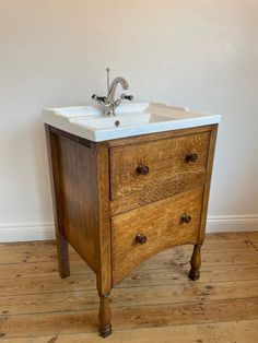 an old wooden sink cabinet with two drawers