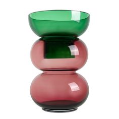 a pink and green vase sitting on top of each other