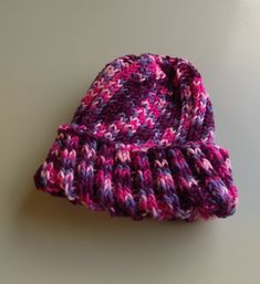 Deeply rib-knit for warmth and comfort, this cute knitted hat is worked on circular needles for a neat finished appearance.  The colors range from pale pink to bright pink to deep berry.  A nifty reversal of the rib pattern creates a natural fold line for the brim. This hat measures about 6-1/2 inches long and will stretch to fit. Lincoln Park, Circular Needles, Knitted Hat, Pale Pink, Bright Pink, Lincoln, Labour Day, Caps Hats, Rib Knit