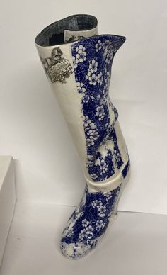 a pair of blue and white boots with flowers on them