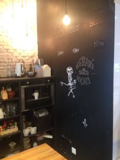 a blackboard with writing on it in a kitchen