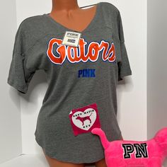 New With Tags Victoria’s Secret Pink Collegiate Collection University Of Florida Uf Gators T-Shirt Cut Out Logo Size Extra Small No Offers Please College V-neck Graphic Print T-shirt, Sporty V-neck Top For College, Pink V-neck Graphic Tee Top, Pink V-neck Graphic Tee, Pink V-neck T-shirt With Letter Print, Sporty V-neck T-shirt For Loungewear, Sporty V-neck Tops For Loungewear, Game Day V-neck Top With Letter Print, V-neck Game Day Top With Letter Print