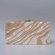 Looking for a stylish and chic statement accessory with a designer touch? You'll love this beautiful Luxury Resort Acrylic Clutch Bag! With its beautiful pearl sheen and its gold design, this stylish acrylic clutch bag won't go unnoticed. Simple and chic, it's the perfect accessory to dress up an outfit for a luxury resort feel. To wear on your way to the cocktail bar, the beach or by the pool, this beautiful acrylic clutch bag is perfect for all occasions and the holiday season! Style: Eclectic Clutch Purse Wedding, Gold Clutch Purse, Purse Wedding, Eclectic Boho, Glitter Clutch, Acrylic Clutch, Gold Clutch, Holiday Bag, Striped Bags