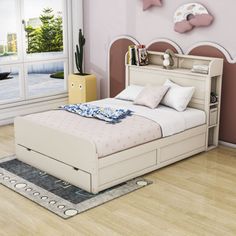 a bedroom with pink walls and white furniture