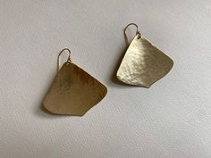 Brass Gingko Leaf Earrings, Petal Shaped Jewelry I hammer and forge these earrings by hand. They are softly textured by hammer marks and have an organic texture and shape.  These brass gingko shaped leaves dangle from 14k gold-fill hooks. Your pair may be slightly different than those shown do to their unique handmade nature. They are about 1 & 1/2 inches long including the hooks, and 1 & 3/8 inch wide. Brass is uncoated and natural so it will oxidize over time to a darker bronze color. I will i Artisan Yellow Gold Hammered Earrings, Artisan Hammered Yellow Gold Earrings, Bronze Hammered Earrings For Gift, Formal Hammered Brass Earrings, Gingko Leaves, Green Box, Branch Design, Ginkgo Leaf, Leaf Earrings