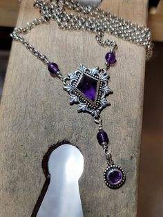 This is a handmade, one of a kind amethyst and sterling silver necklace. In addition to being the birthstone of February, many cultures find spiritual overtones in amethysts. Often viewed as a stone of peace, some believe amethyst's calming presence produces soothing dreams by bringing the dreamer more in tune with the Divine. Amethysts are said to have calming, soothing energy. The centerpiece of the necklace measures about 1 inch long by just over .75 inch wide. The dangling faceted amethyst i Purple Gem Necklace, Gothic Sterling Silver Jewelry With Adjustable Chain, Sterling Silver Dangle Necklace, Sterling Silver Dangle Necklaces With Hallmark, Adjustable Sterling Silver Dangle Necklaces, Adjustable Sterling Silver Drop Necklace, Victorian Silver Jewelry With Birthstone, Purple Teardrop Metal Jewelry, Gothic Dangle Necklaces As Gifts