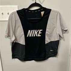 Nwt Color Block Short Sleeve Cropped Dri-Fit Nike Tshirt New With Tags, Never Worn Gray Crew Neck Athleisure Tops, Gray Crew Neck Sports Top, Nike Athleisure Tops With Letter Print, Nike Gray Tops With Letter Print, Nike Gray Sports Top, Gray Nike Sports Top, Nike Black Crew Neck Top, Graphic Tee For Workout In Black, Graphic Tee For Workout Black Top